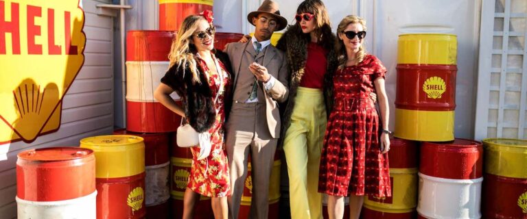 Visitors dressed in elegant vintage fashion at the Goodwood Revival.