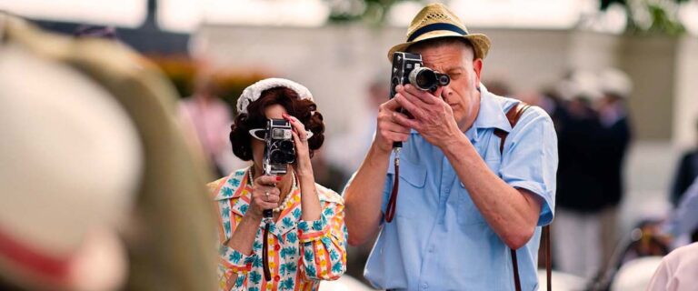 Visitors filming the Goodwood Revival with vintage cameras.