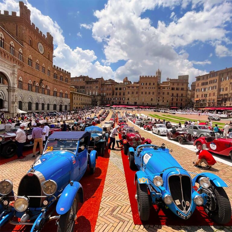 Historic race cars gathered in Siena's Piazza del Campo during the Mille Miglia.