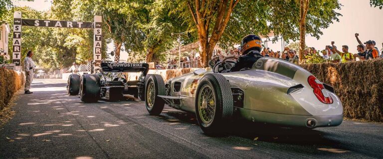 Historic racing cars waiting at the start of the Goodwood hill climb.