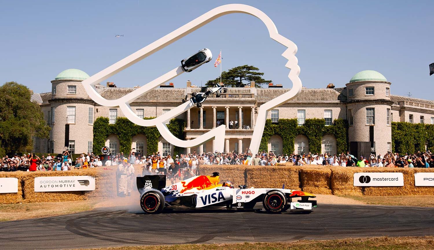 Formula One car drifting in front of the iconic Central Feature at the Goodwood Festival of Speed.