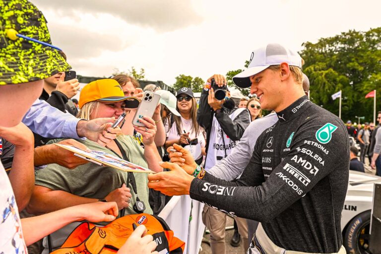 Formula One driver signing autographs for fans at the Goodwood Festival of Speed.