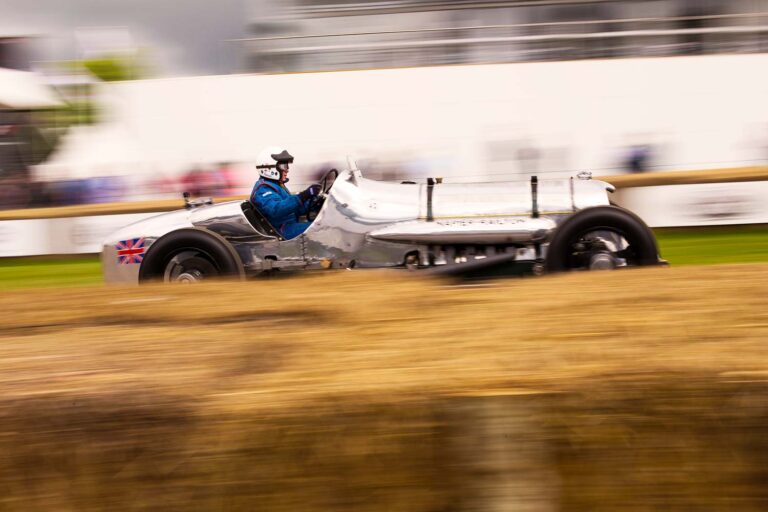 Historic Grand Prix racing car climbing the Goodwood Festival of Speed hill.