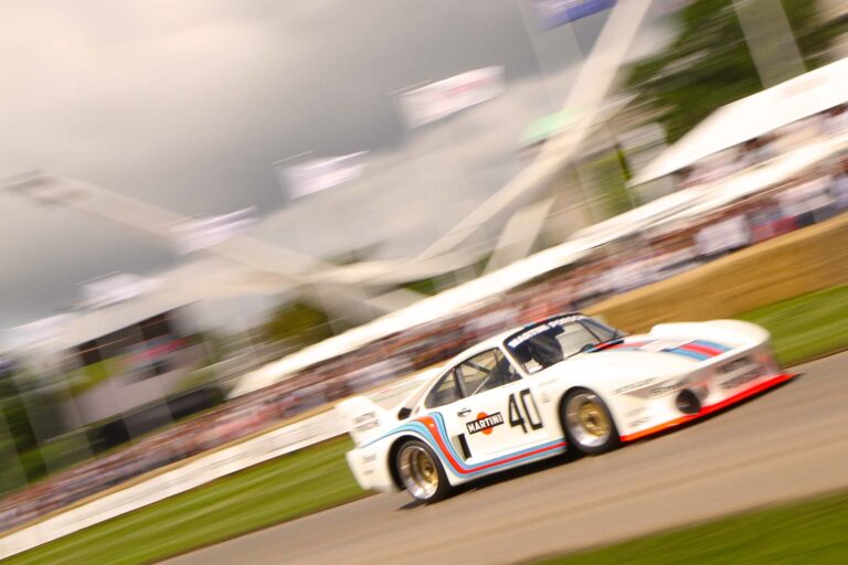 Porsche 935 in Martini Racing colours climbing the Goodwood Festival of Speed hill.