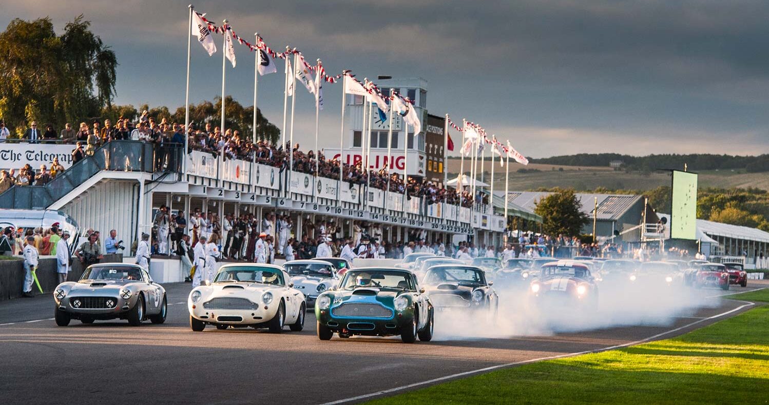 Historic racing cars on the start-finish straight at the Goodwood Revival.