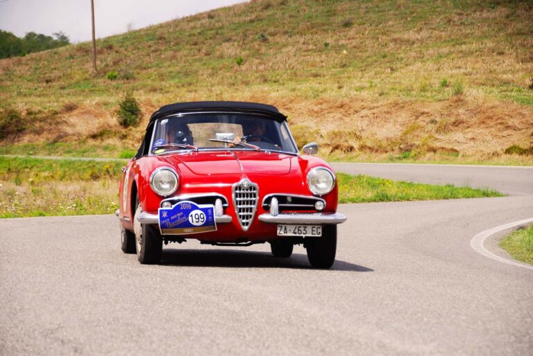 Alfa Romeo Giulietta Spider driving through a sweeping bend during the Gran Premio Nuvolari in Italy.