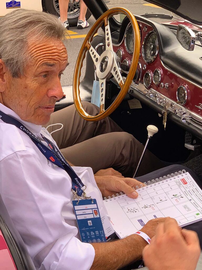 Co-driver studying the roadbook inside a classic Mercedes-Benz during the Mille Miglia.