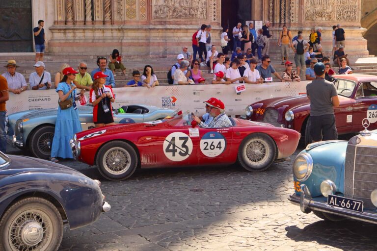 Historic racing cars in front of Siena Cathedral during the Mille Miglia.