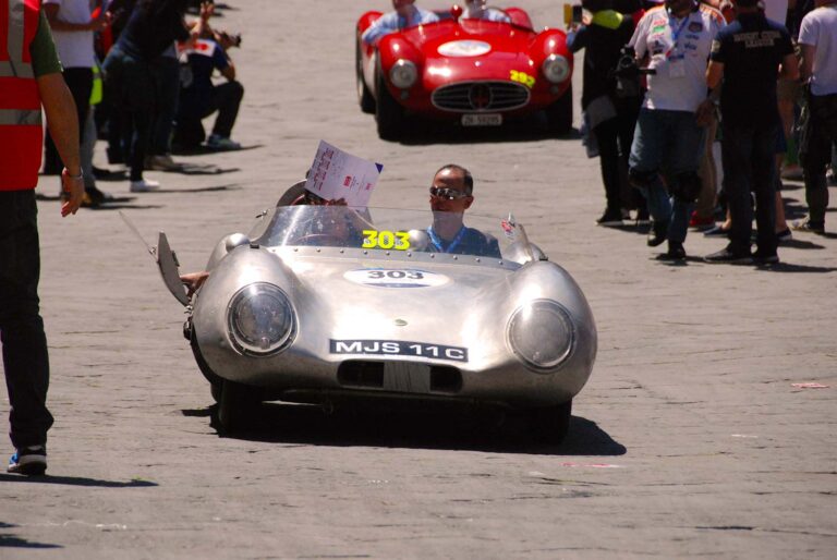 Silver Lotus racing car during the Mille Miglia in an Italian historic square.