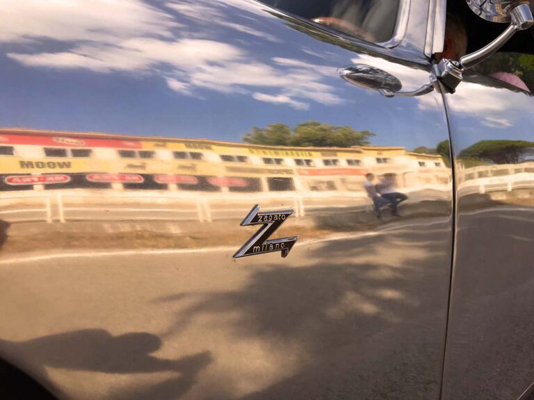 Zagato Milano emblem reflected beside the historic Cerda pit buildings during Targa Florio Live in Sicily.