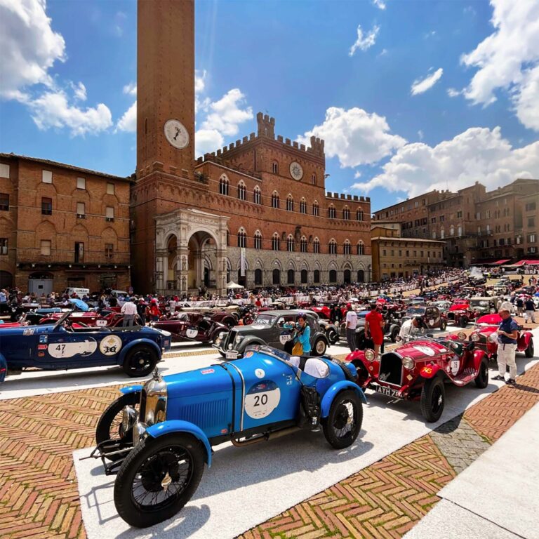 Historic race cars gathered in Siena's Piazza del Campo during the Mille Miglia.